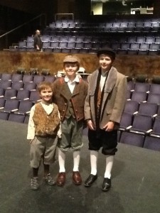 Aidan (Tiny Tim), Seamus (Child Scrooge) and Nathan (Sam Cratchit) enjoy a moment on stage before dress rehearsal begins.