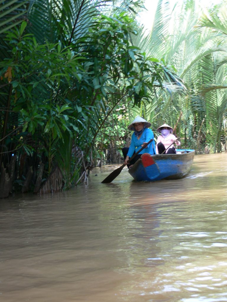 Women rowing boat, Mekong Delta, Vietnam
