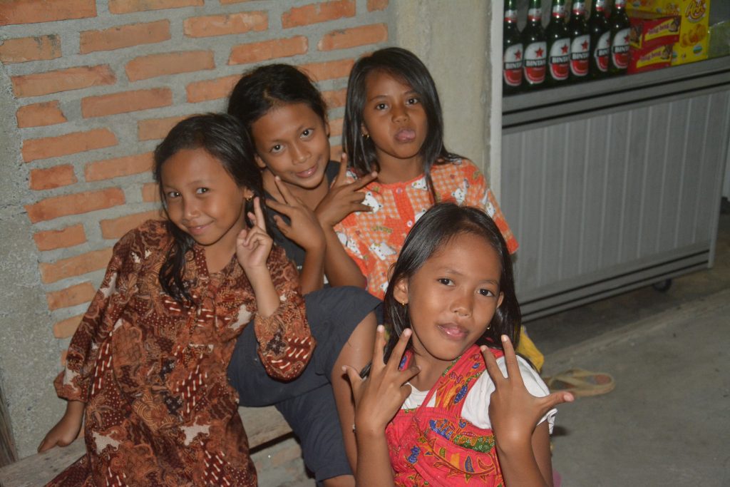 Girls joking around with Nathan and Seamus in Bukit Lawang, Indonesia