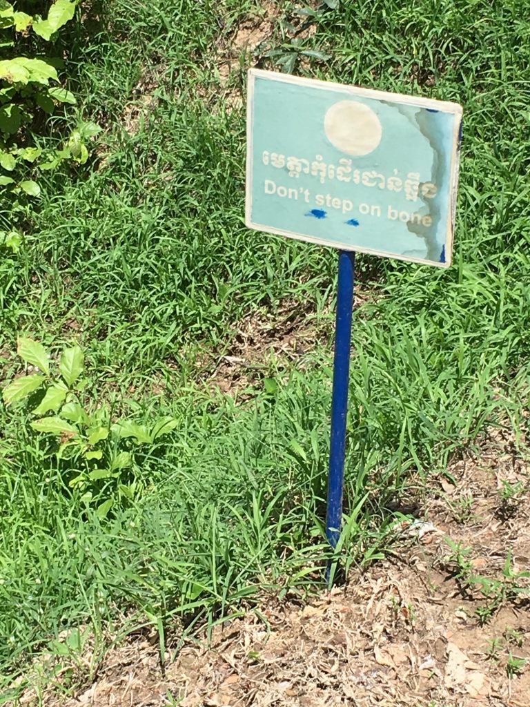 Sign warning of bones at The Killing Fields, Cambodia