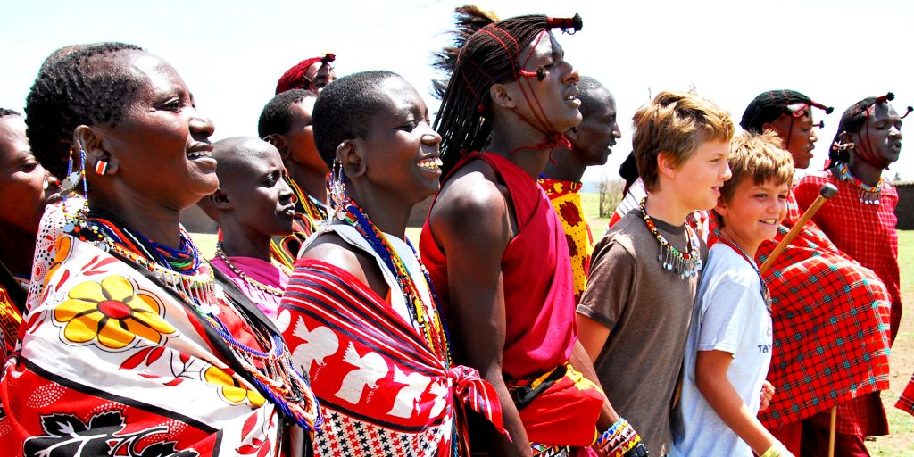 boys with Maasai people in traditional dress