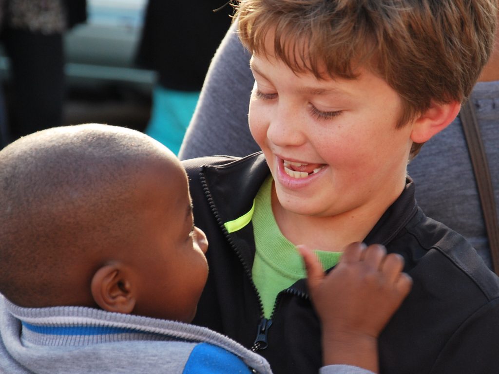 Boy holding baby in South Africa