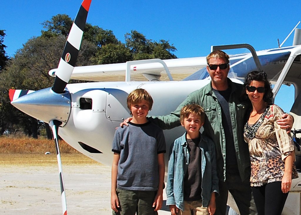 family in front of plane
