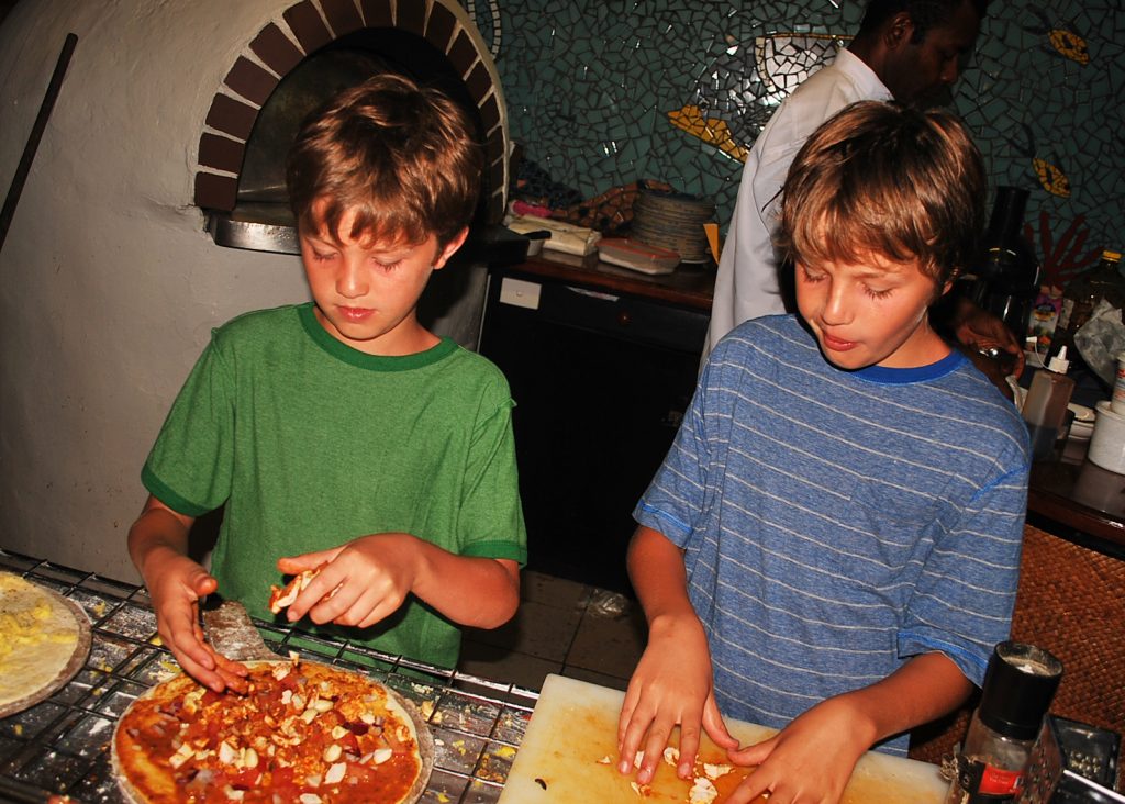 Boys making pizzas