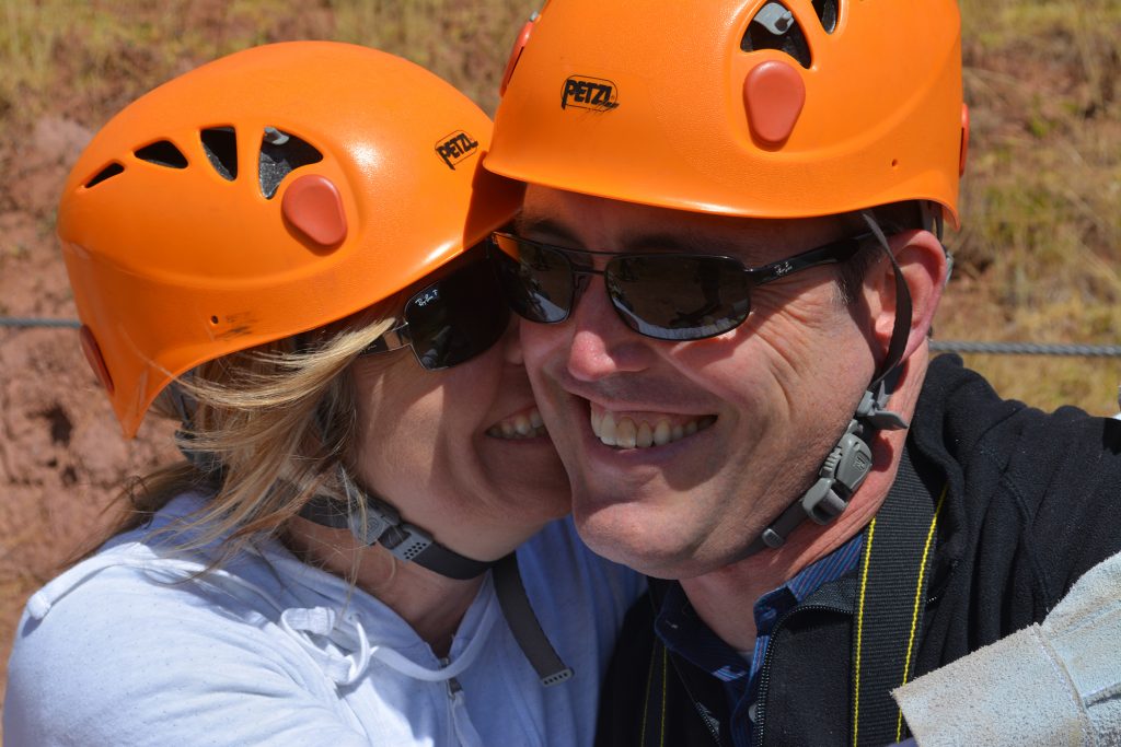 Couple with helmets smiling together