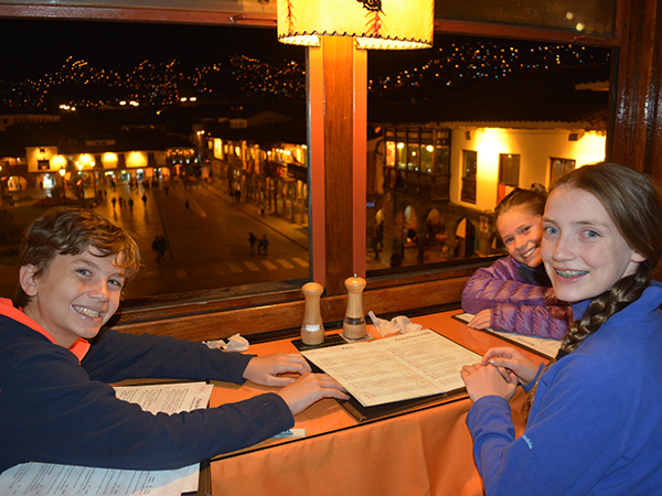 Kids at table with town square in background