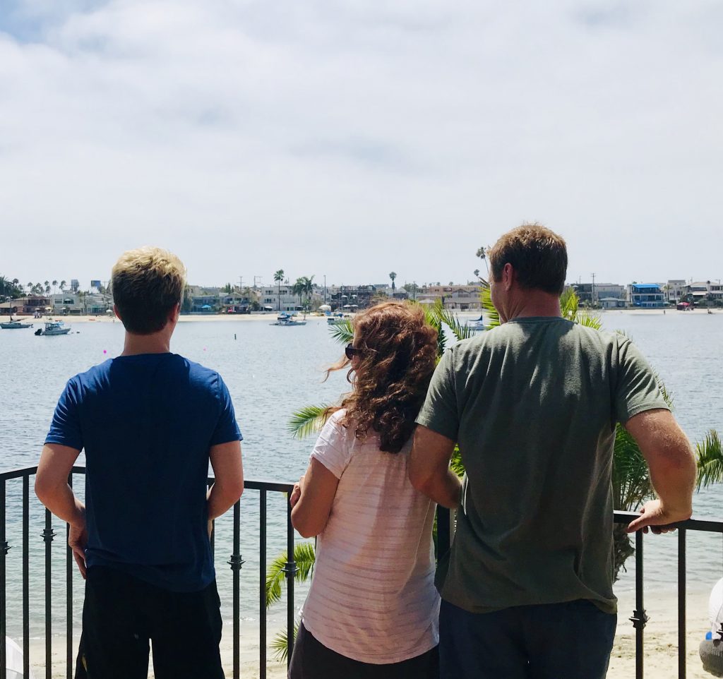 Parents and teenage boy looking out over Mission Bay