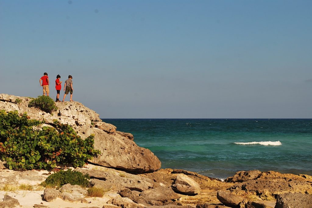 Boys looking over Caribbean Sea